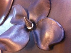 Molded leather flower with spike for center