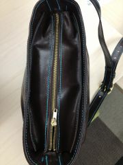 Handbag close up showing zipper placket along the top