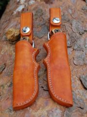 Left and right handed sheaths with removal dangler