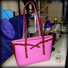 Front view of croc+ pink leather tote