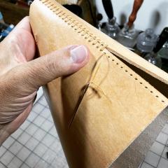 Hand stitching each end of purse.jpg